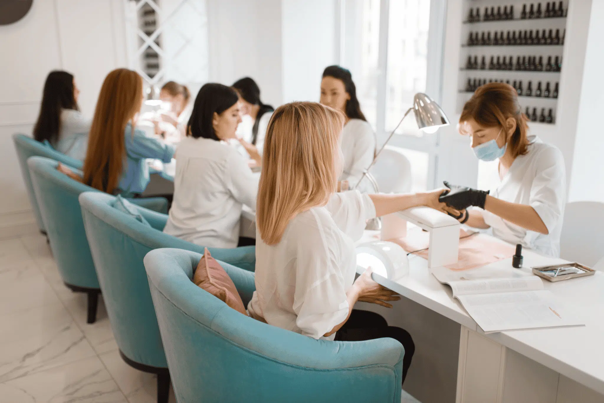 Nail salon professionals serving clients in a salon nail salon professionals serving clients in a salon