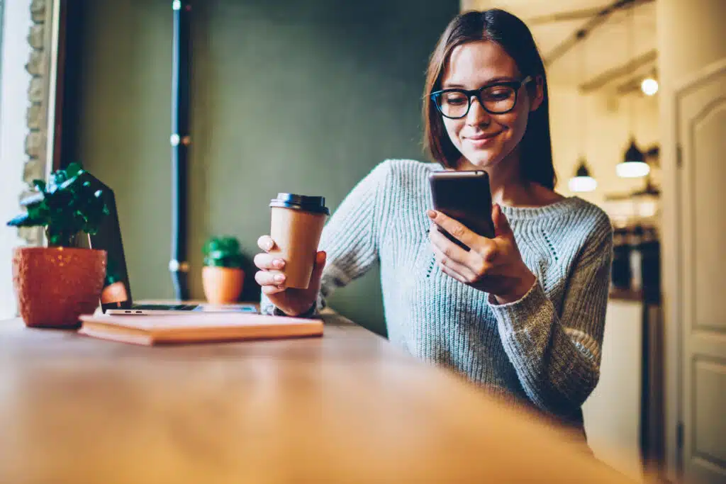 A person checking their smartphone, receiving an appointment reminder notification